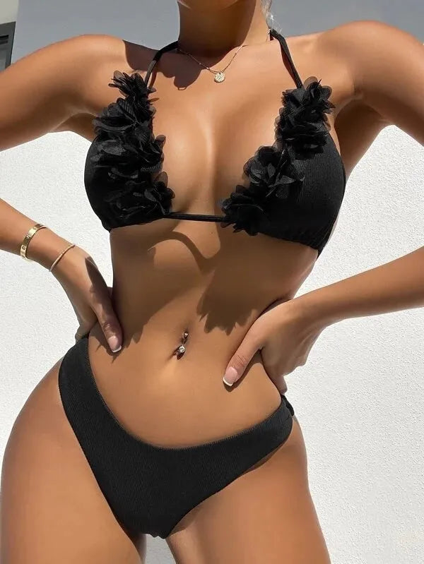 Black gathered polyester two-piece women's swimwear set with top and shorts on a model