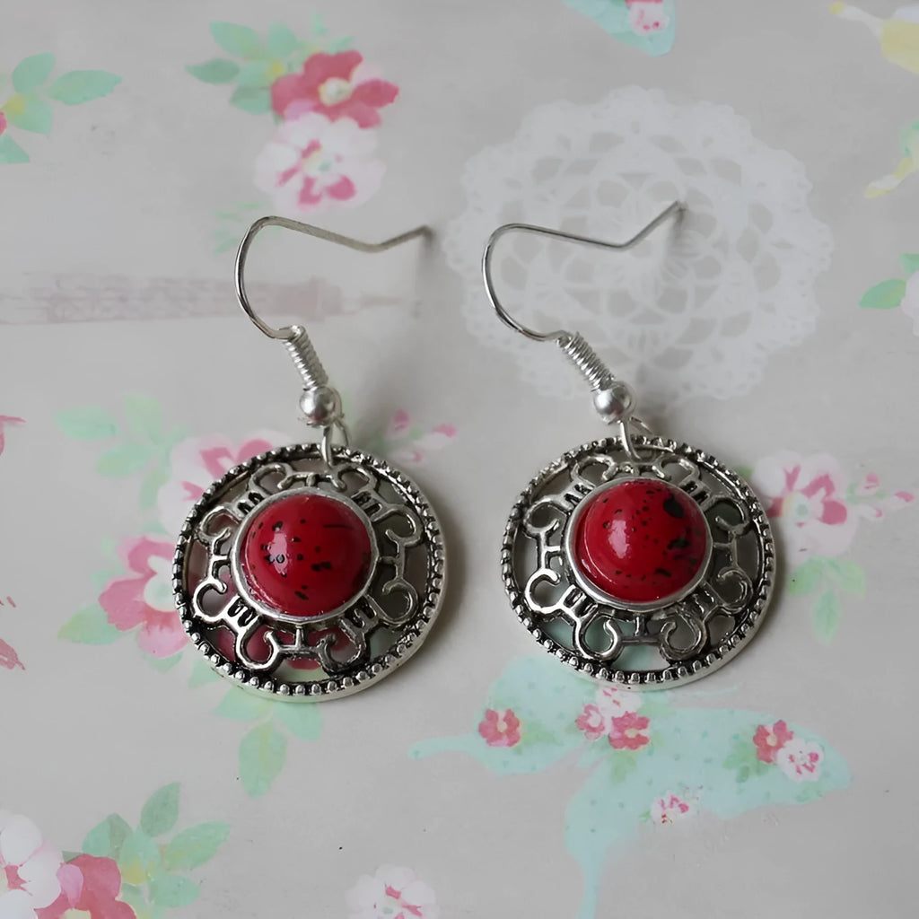 Handmade ethnic earrings with a Tibetan silver geometric flower disk design and turquoise stones.
