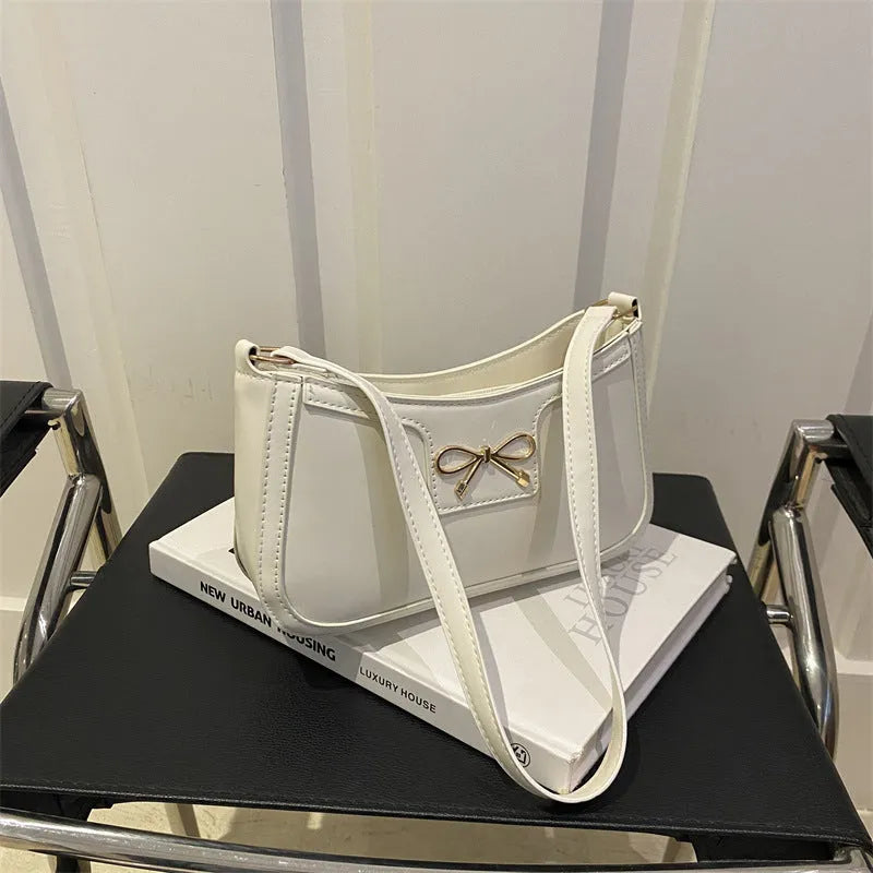 Portable PU shoulder bag in western baguette style with bow detail, 24x14x5 cm, available in multiple colours