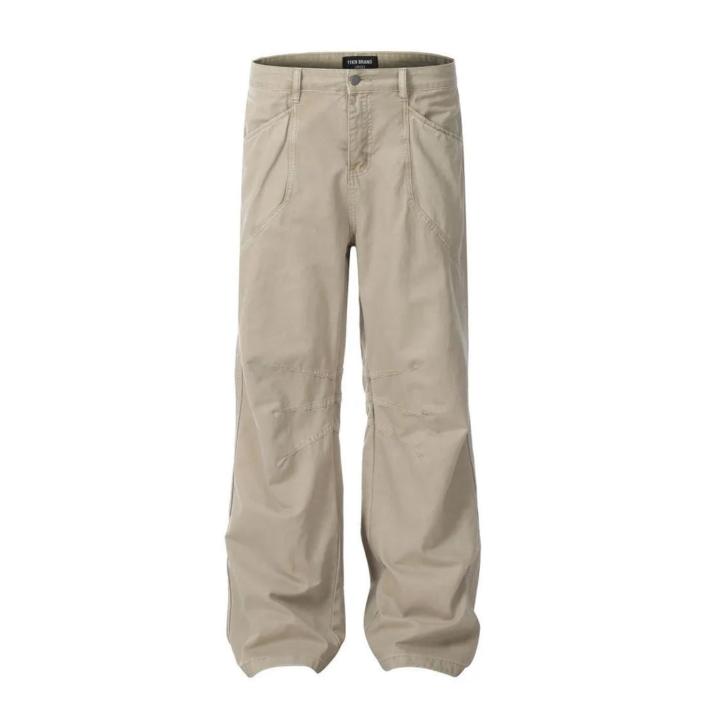 Men's brown straight-leg cotton trousers showing high-waist design with wide leg opening and zipper fly