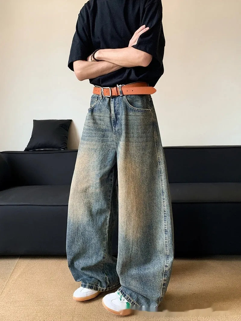 Men's retro blue distressed denim trousers with wide leg cut and vintage wash detailing