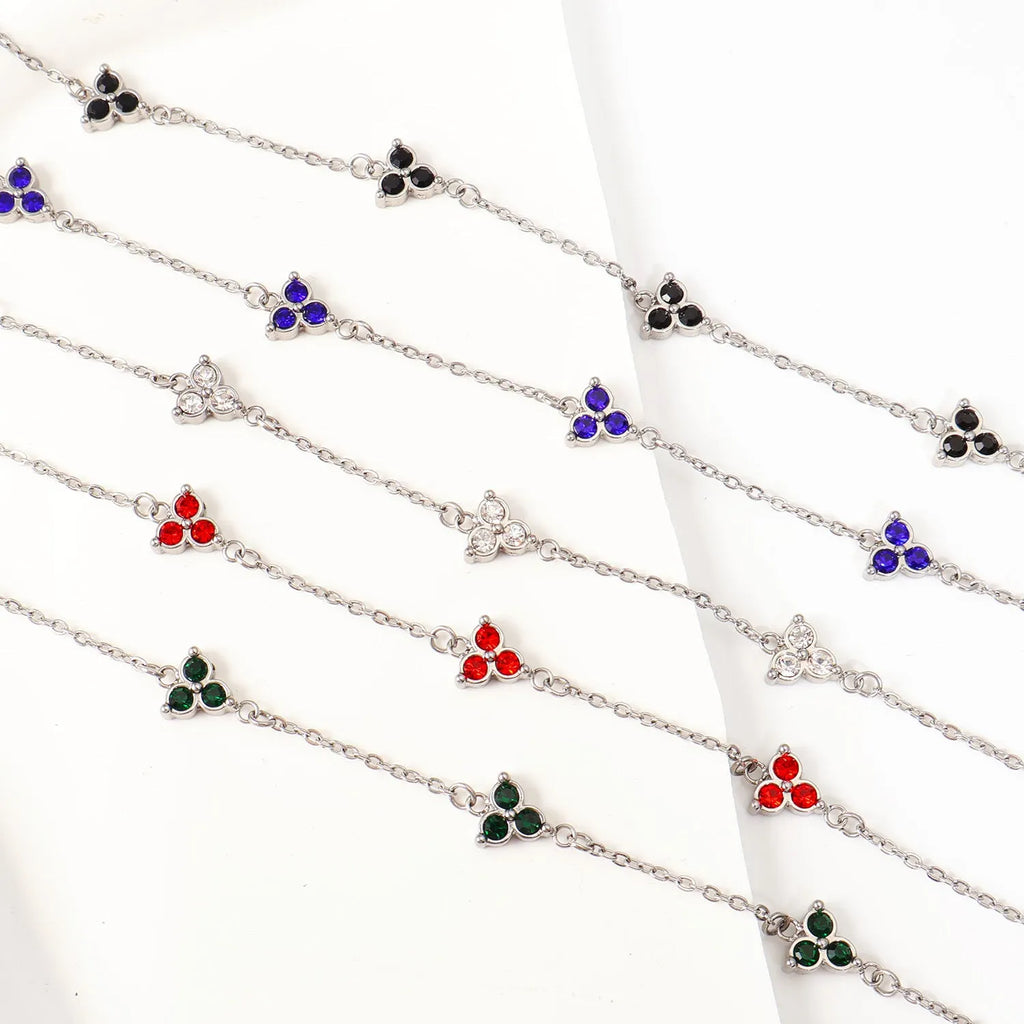 Women's stainless steel bracelet with three triangular diamond charms in geometric design with coloured stones