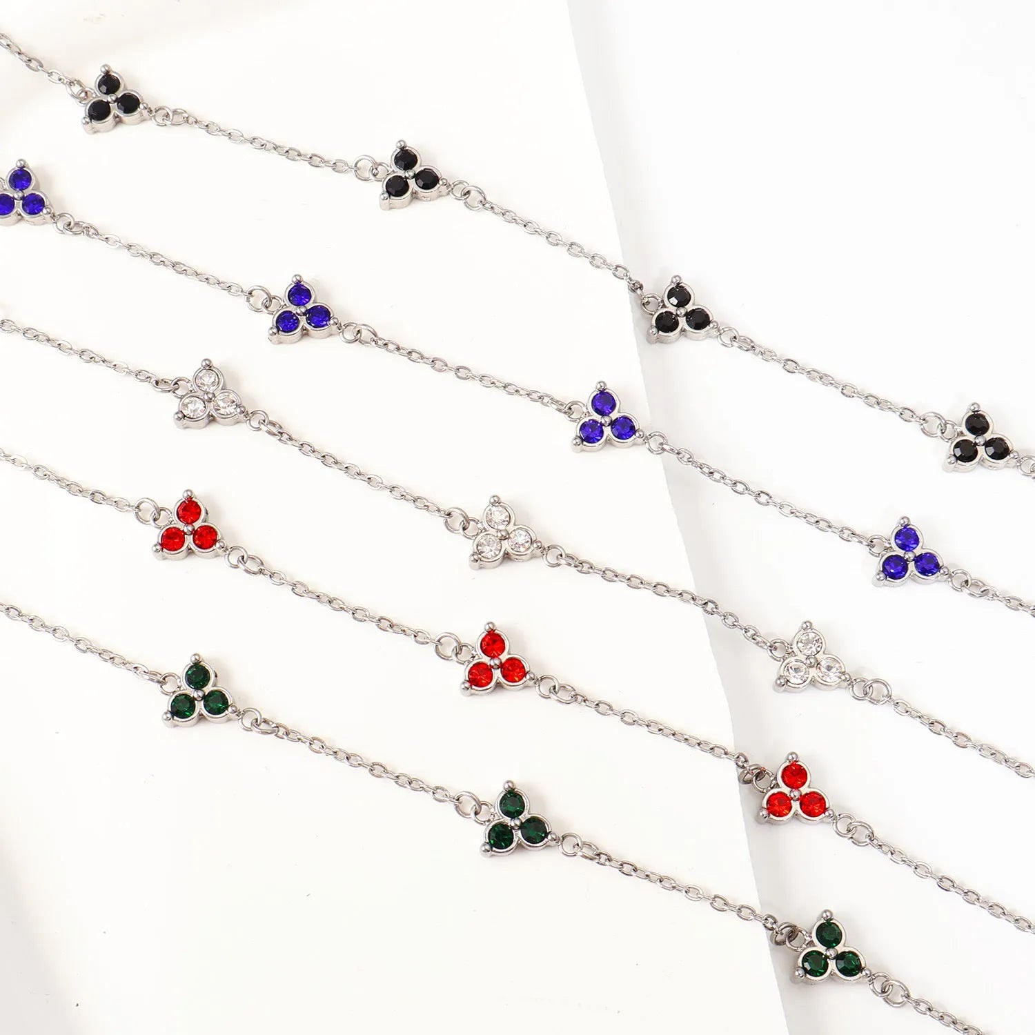 Women's stainless steel bracelet with three triangular diamond charms in geometric design with coloured stones