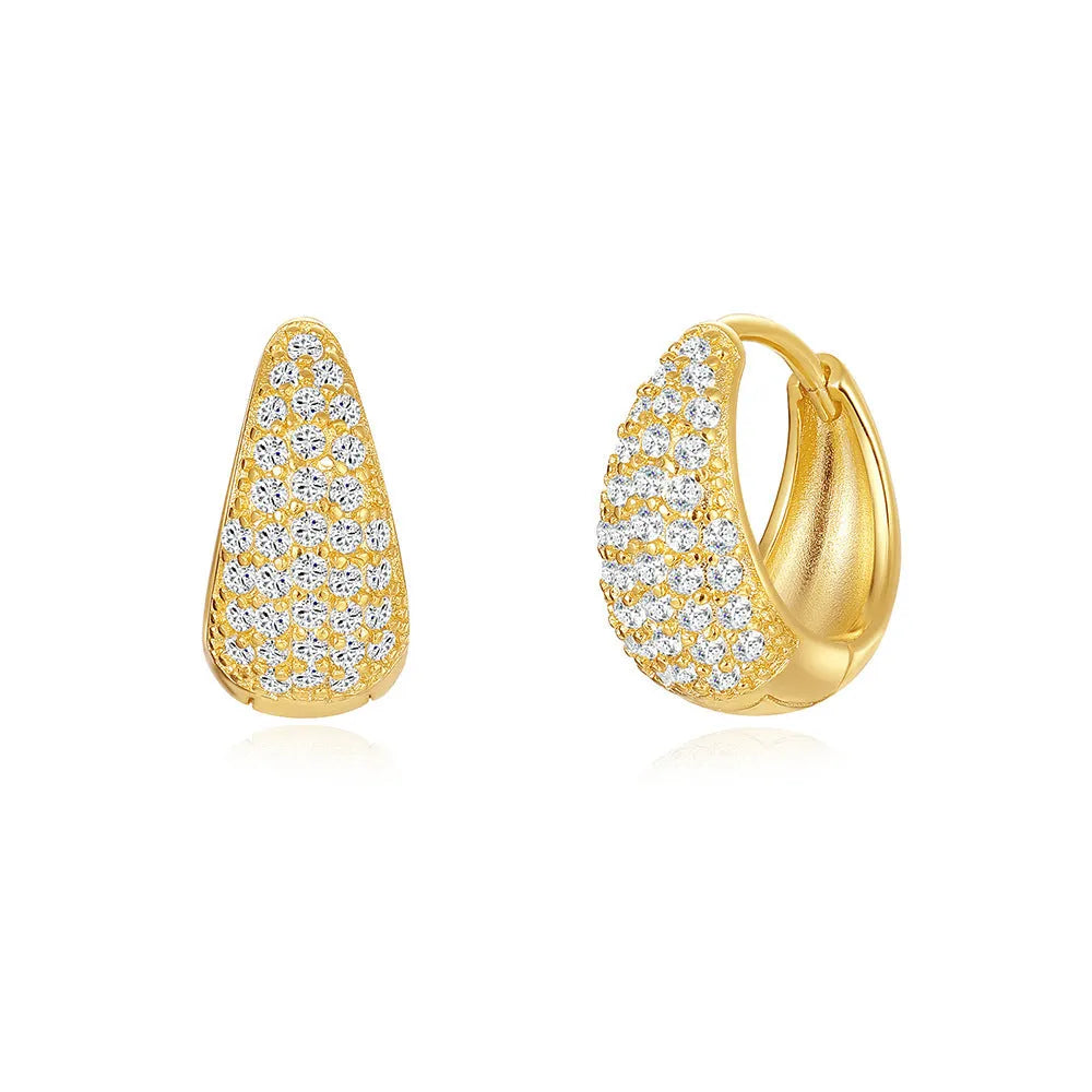 A pair of round, geometric brass earclip earrings with a gold electroplated finish.