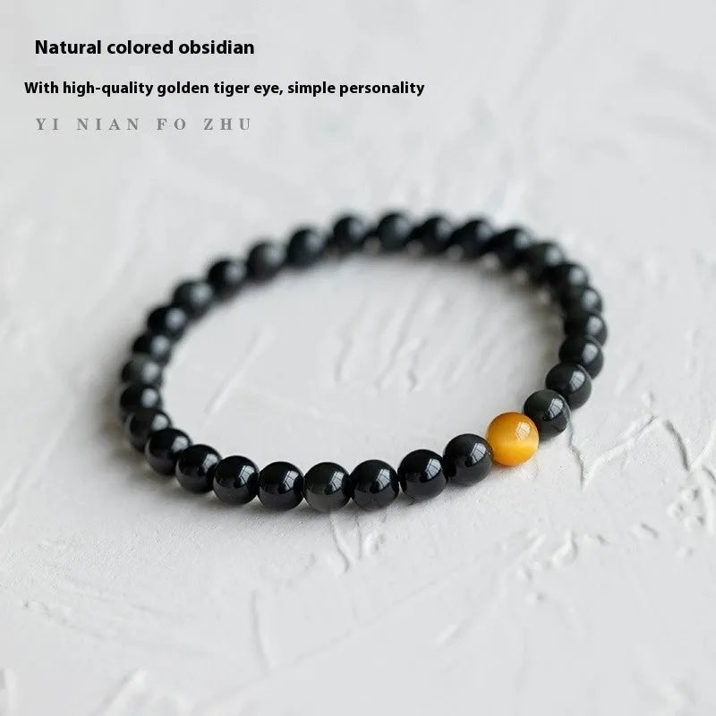 Natural black obsidian bracelet with geometric beads in 10mm size on neutral background