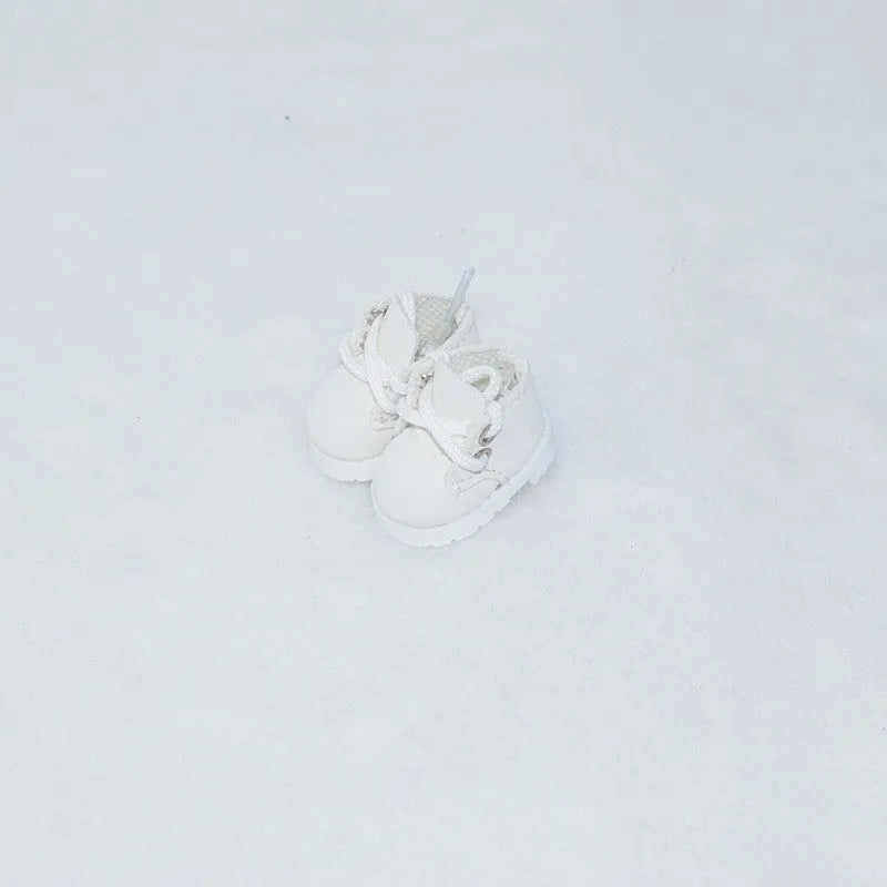 One pair of small black PU leather doll shoes for a 17cm high doll.