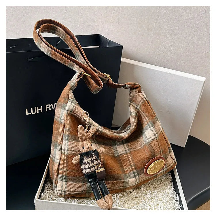 Large capacity soft woolen shoulder bag for women in khaki with pendant, horizontal square shape with sewing line detail.