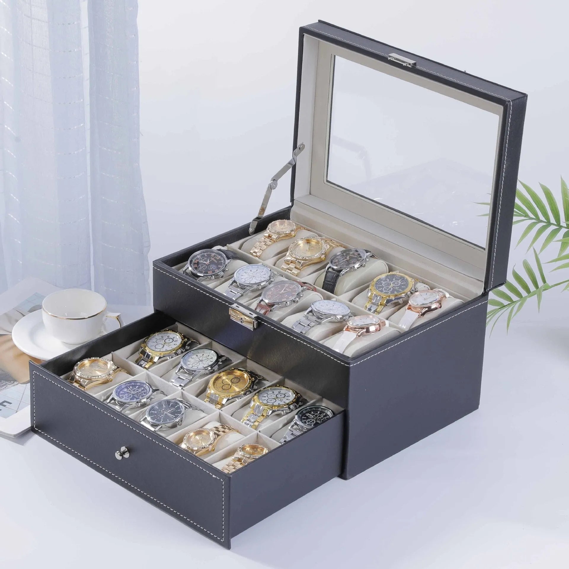 Grey leather watch storage box with clear dustproof lid showing interior watch compartments