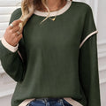 Women's loose knit top with drop shoulders and four leaf clover contrast colour trim