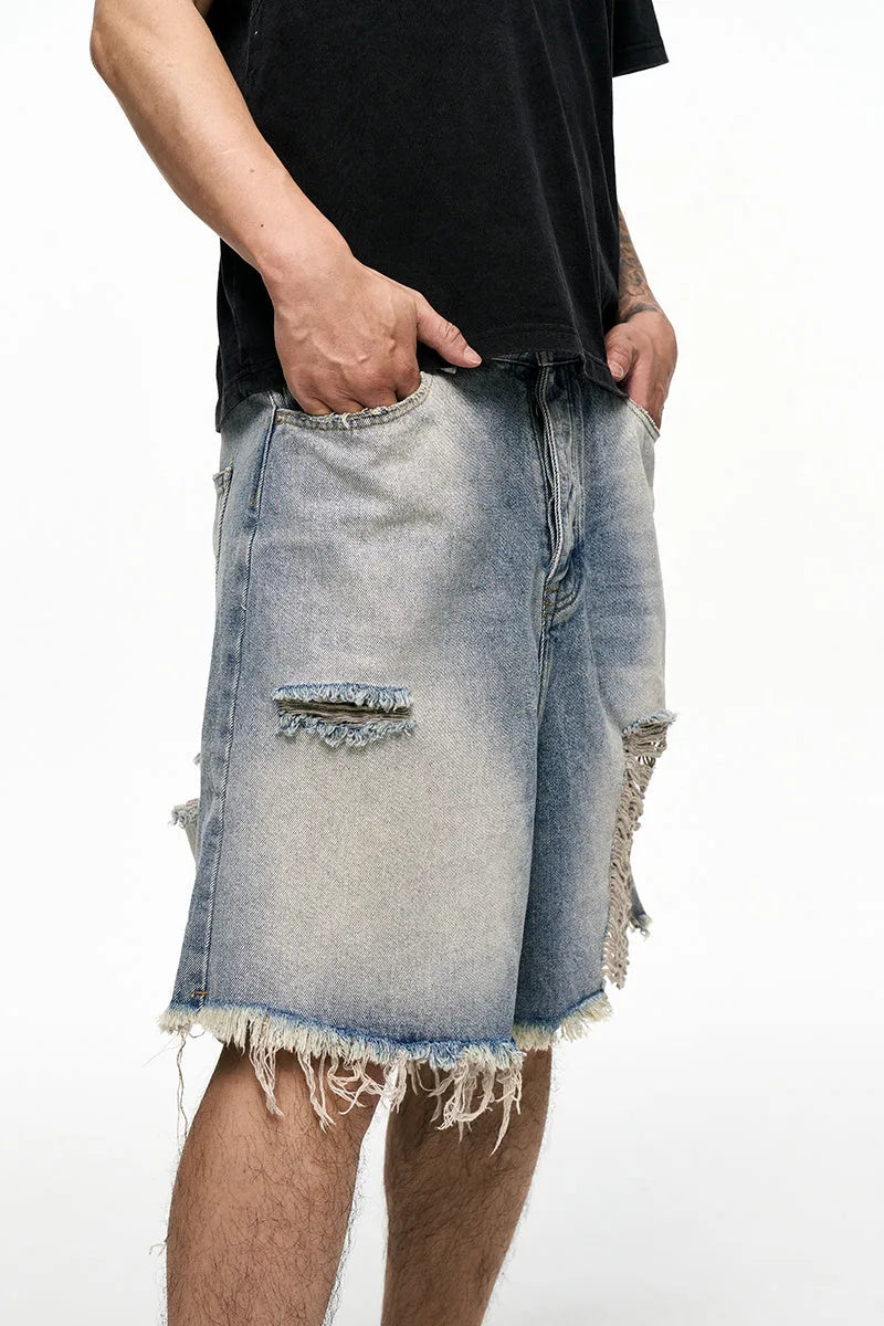 Light blue retro washed men's baggy denim shorts on a hanger showing wide leg fit.