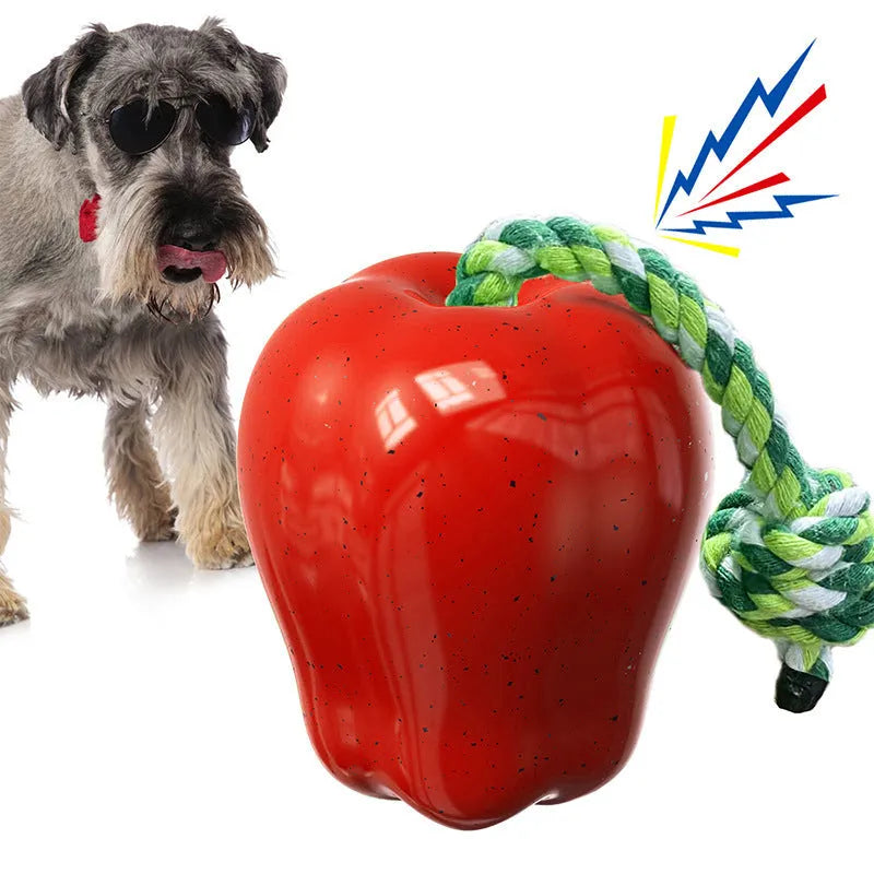 Green plastic dog chew ball with food dropping design and squeaker for dental health