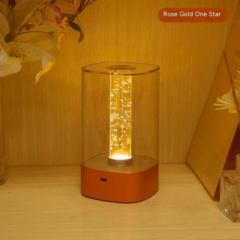 Rose gold LED touch atmosphere light with Auspicious Cloud pattern on a bedside table, USB charging cable included