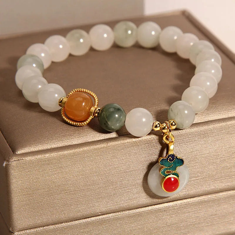 Ice jade colour women's bracelet with xiangyun buckle and pearl details.