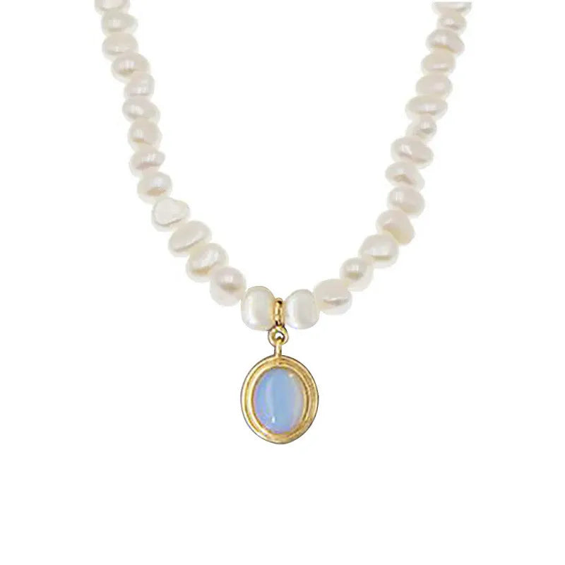 Silver geometric necklace with an irregular pearl pendant on an adjustable chain.