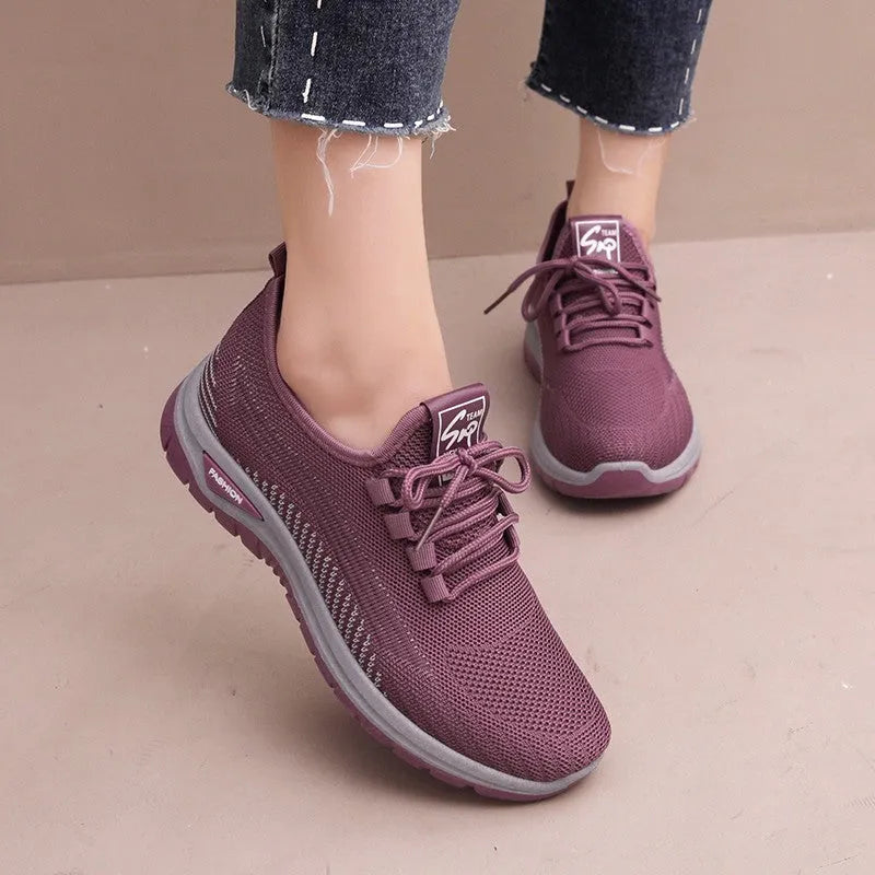 Women's breathable mesh lace-up sneakers with cross straps, round toe, and low heel in black, gray, and purple