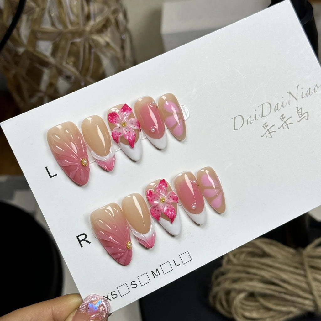 French style artificial nails with 3D lily and ice flower design on almond-shaped plastic tips.