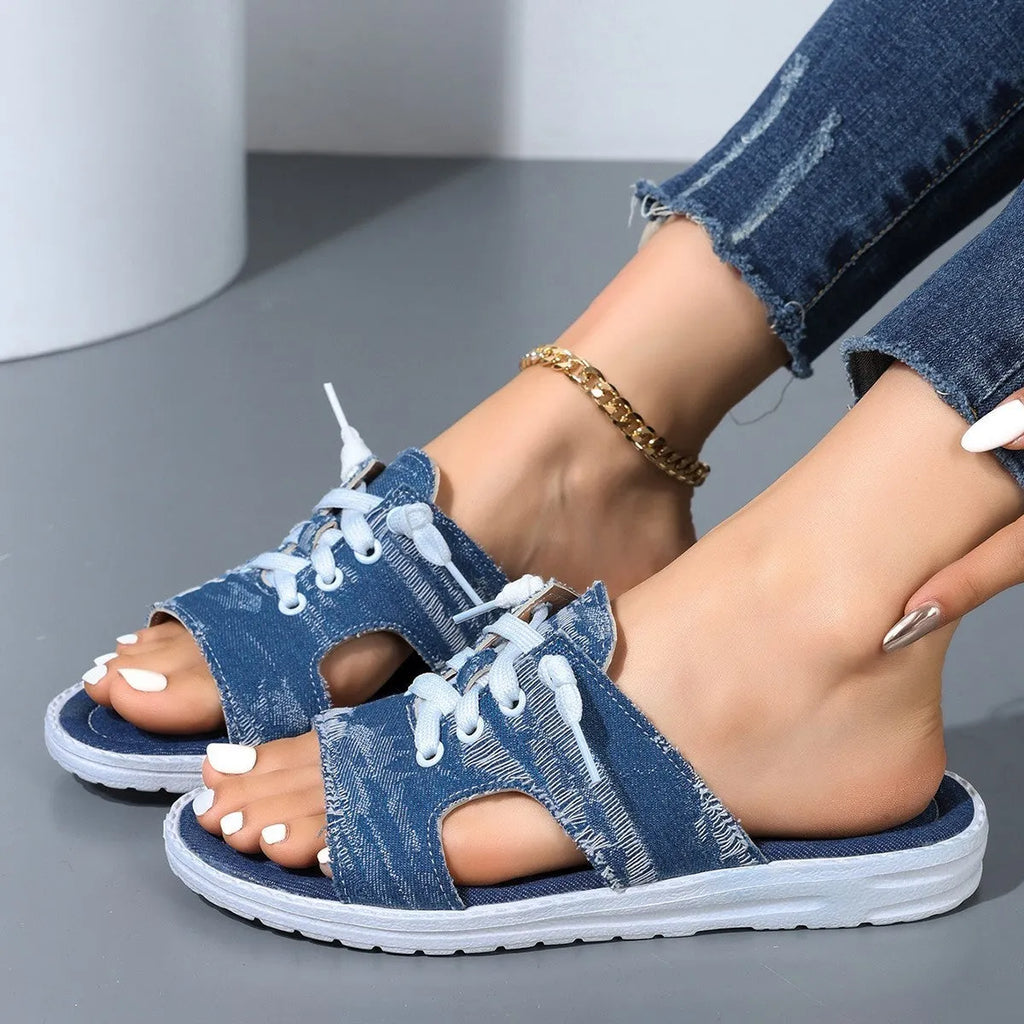 Blue women's Roman style flat canvas slippers with a cloth upper and rubber sole.