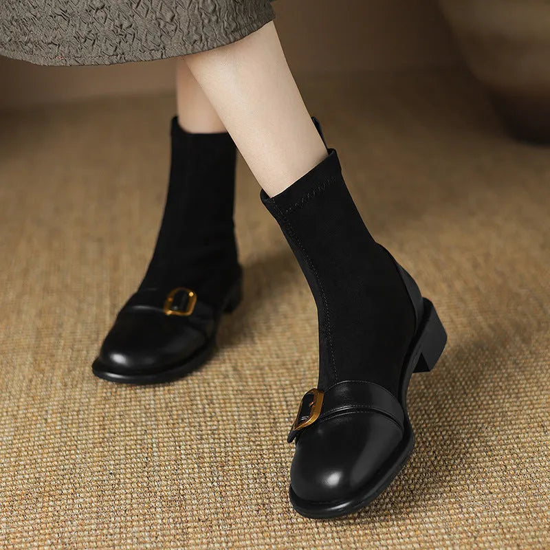 Women's black low heel Martin ankle boots with belt buckle stitching and lace-up front.