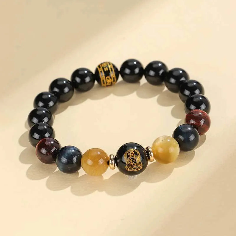 Black agate beaded bracelet with tiger eye stones in ethnic style on plain background
