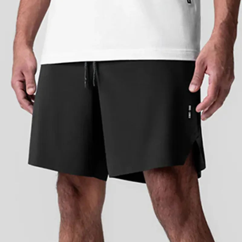 Men's quick-drying polyester sports shorts in knee length with multi-bag design, black colour, front view