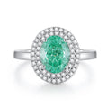 Women's geometric S925 sterling silver ring with elliptical emerald centre stone and diamond accents