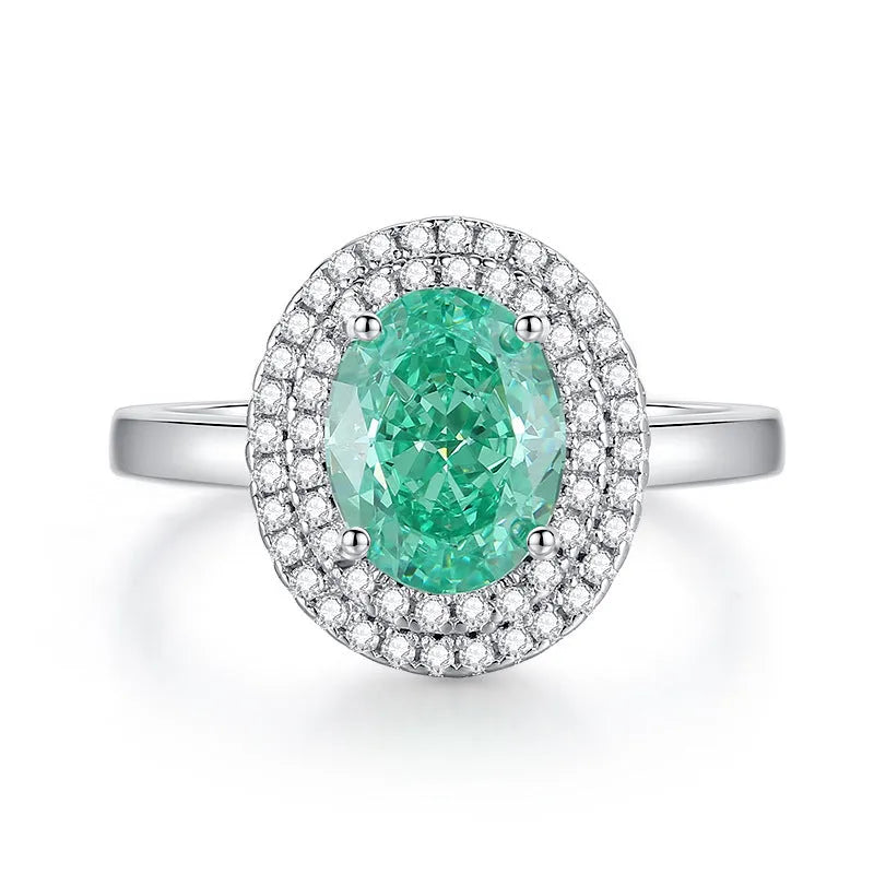 Women's geometric S925 sterling silver ring with elliptical emerald centre stone and diamond accents