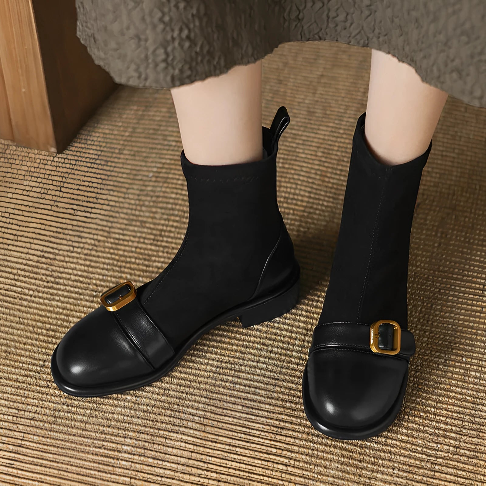 Women's black low heel Martin ankle boots with belt buckle stitching and lace-up front.