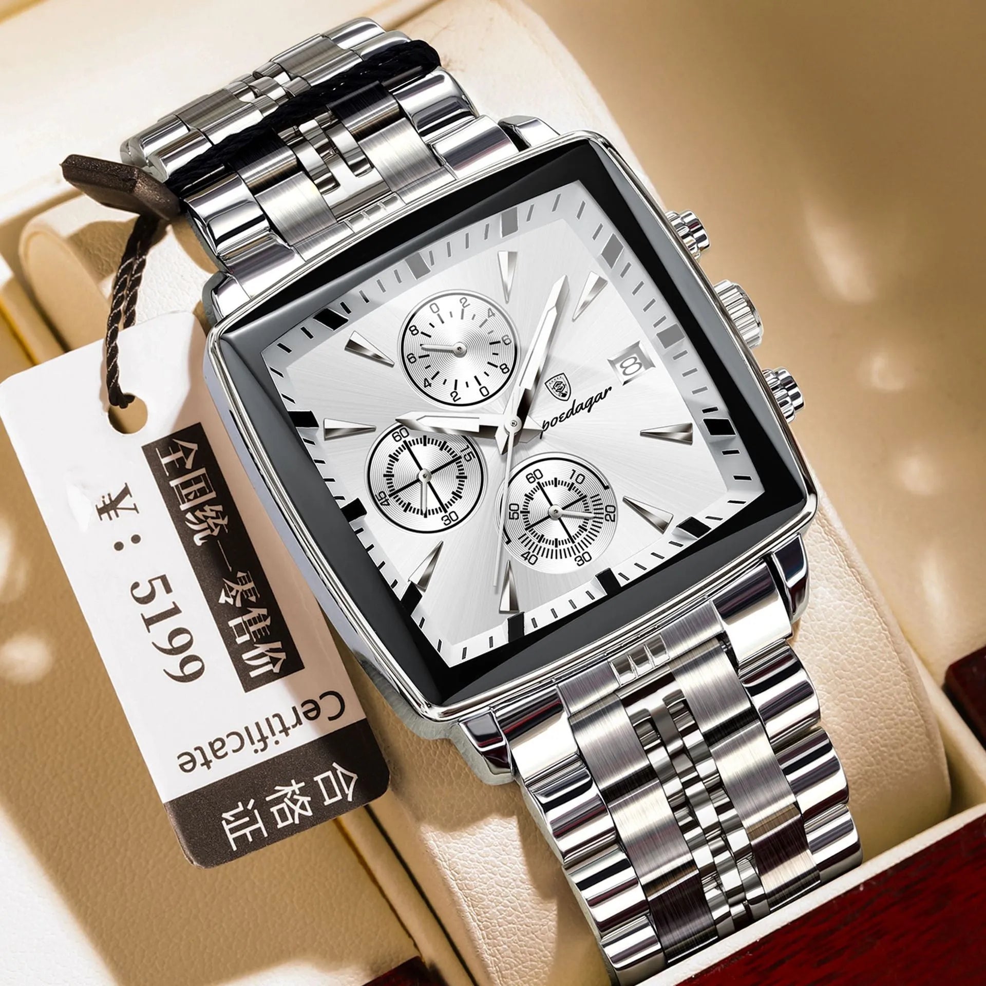 Square faced men's business watch with stainless steel strap on a wrist, showing a gold and blue colour variant.