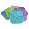 Green silicone pet licking pad 20x20cm with suction cup base on a tiled floor