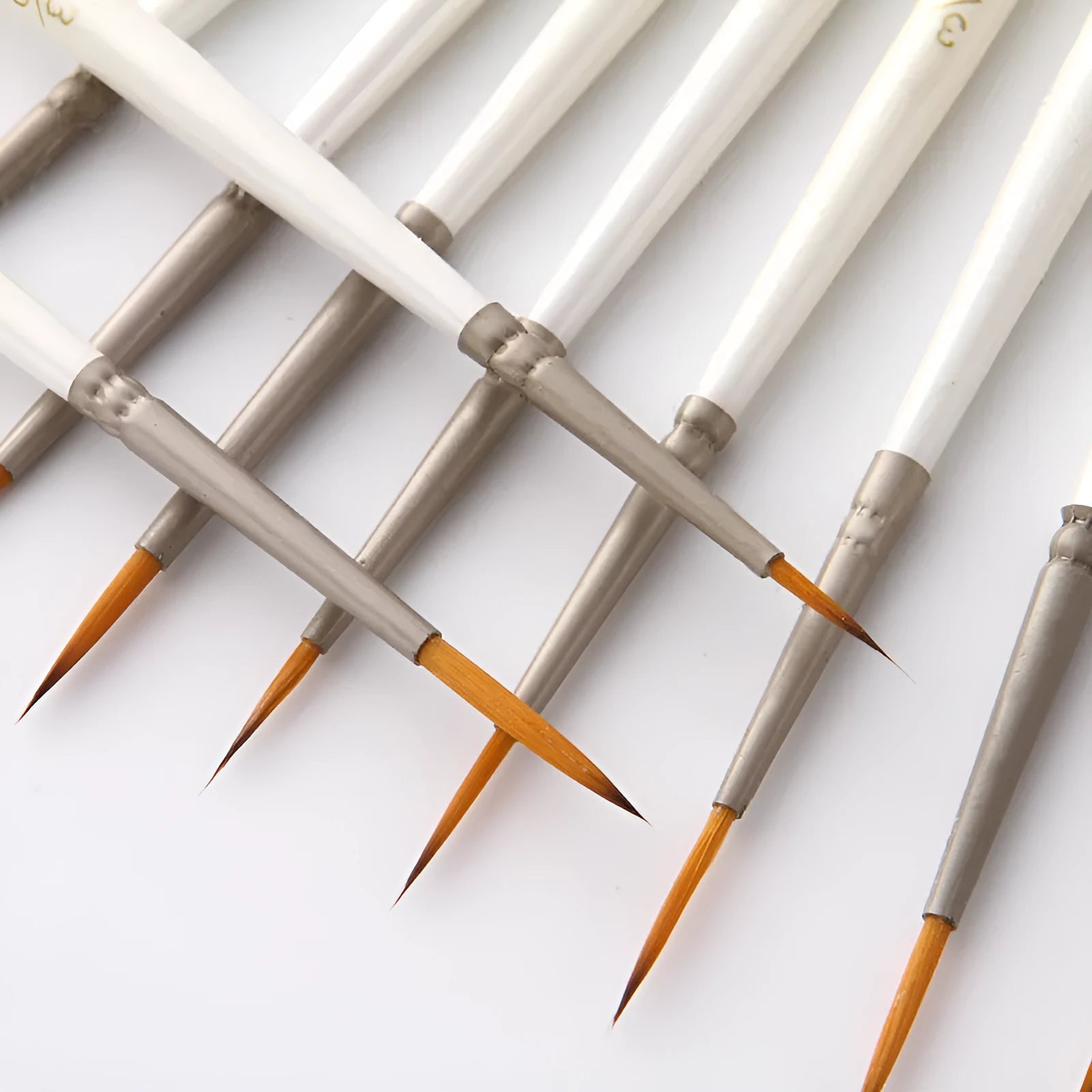 Set of 12 Pearl White handled artist paint brushes with nylon wool heads, sizes 000 to 4/0.