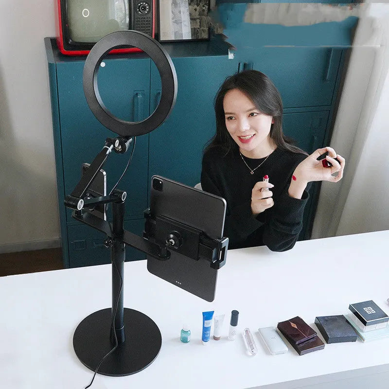 Black aluminium alloy floor stand holding a mobile phone with built-in fill light switched on