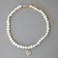 Silver geometric necklace with an irregular pearl pendant on an adjustable chain.