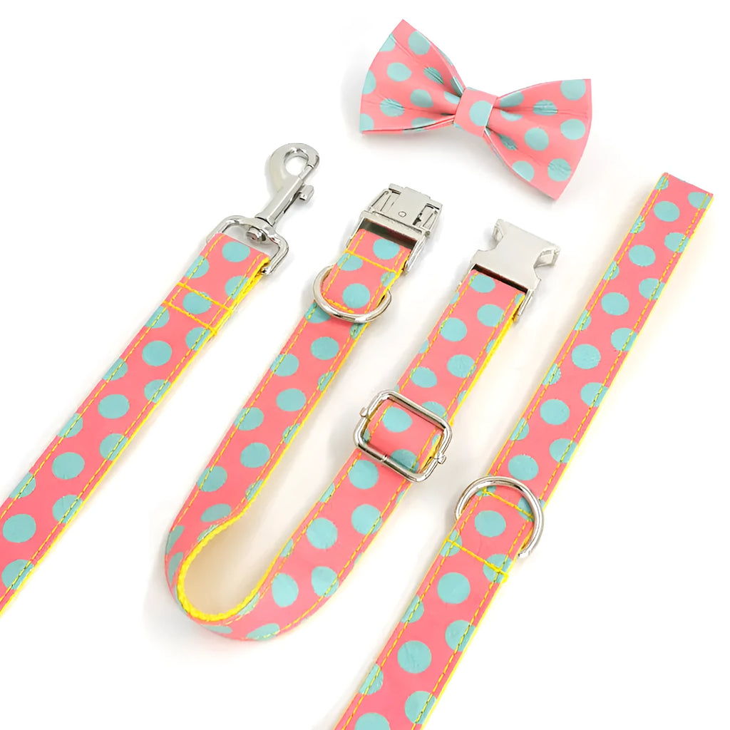 Yellow polka dot pet collar and matching hand-held traction rope lead set on plain background