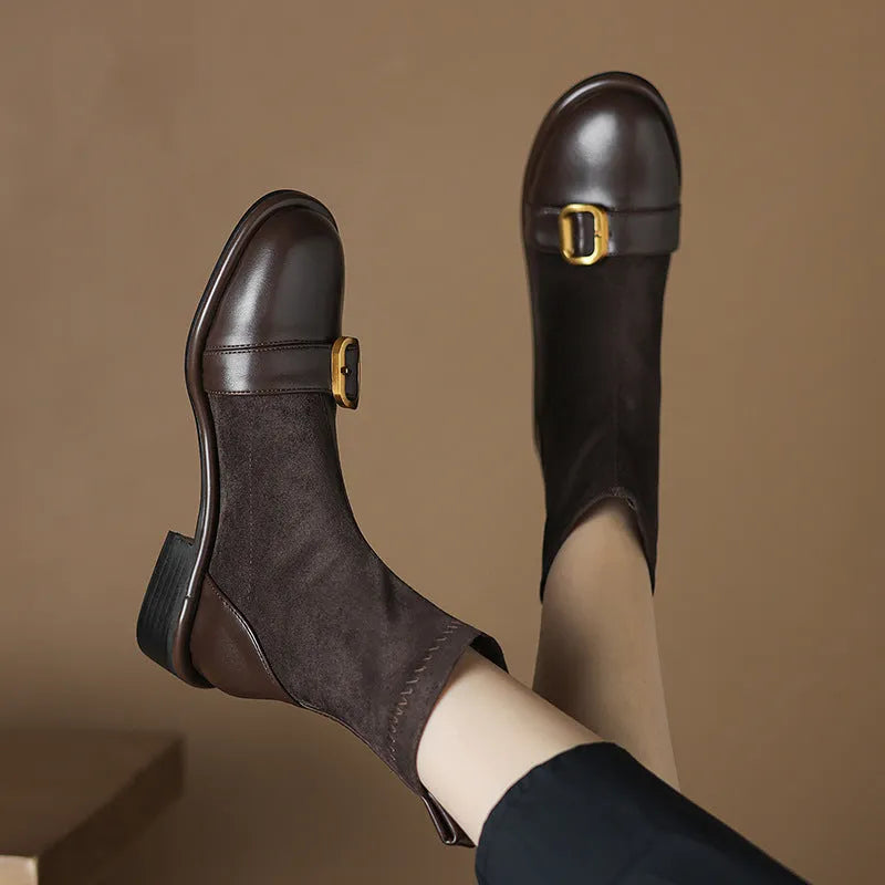 Women's black low heel Martin ankle boots with belt buckle stitching and lace-up front.