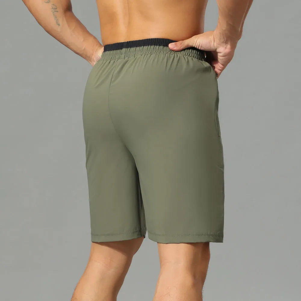 Men's Ice Silk quick-drying loose cropped running pants in army green on a model