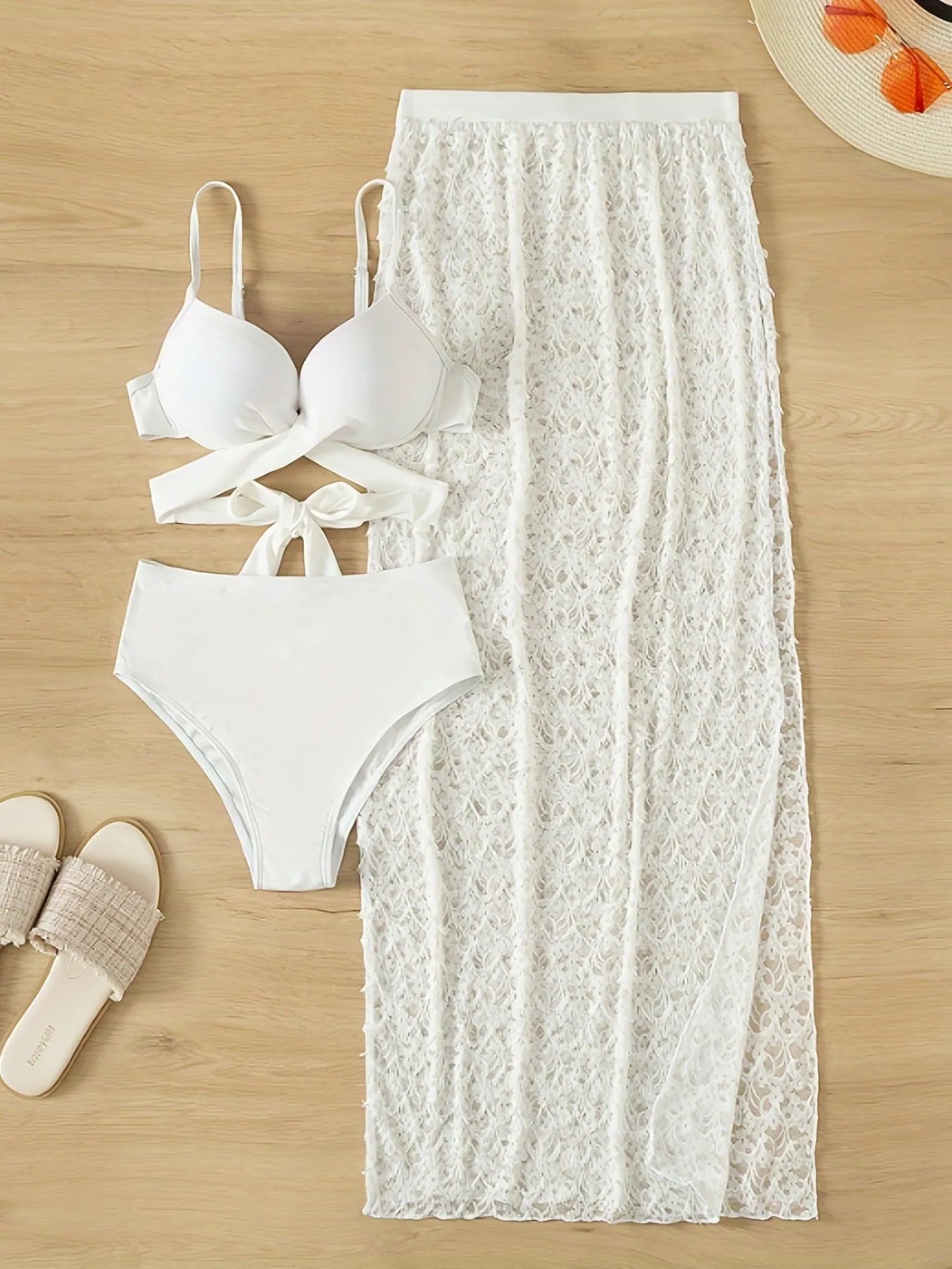 White three-piece nylon swimsuit set with gathered long skirt, top, and briefs on woman.