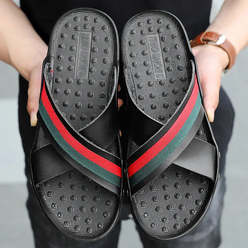 Men's black leather flip-flops on a white background, showing the cowhide upper strap and textured PU sole.