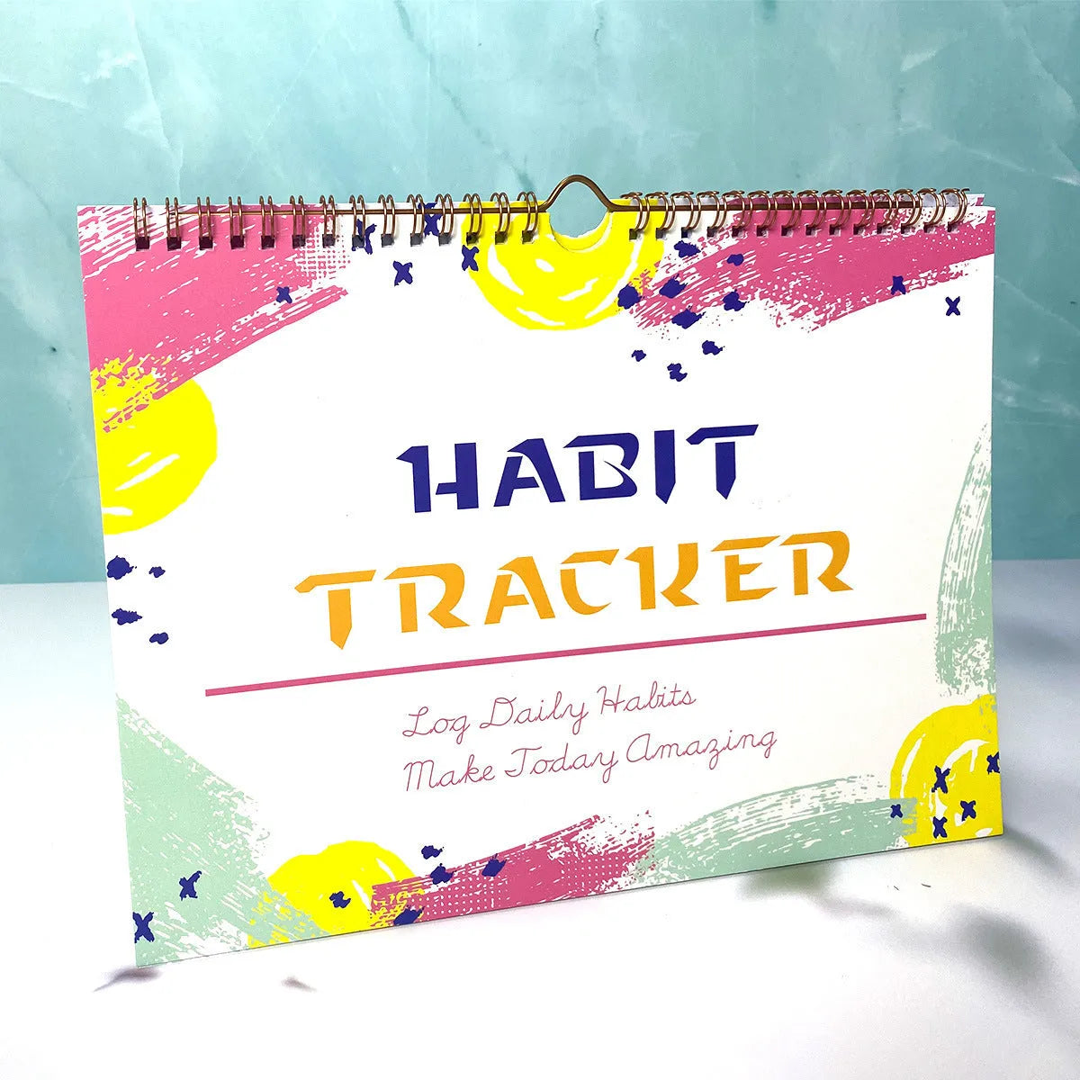 English habit tracking journal with 12 pages in 21cm by 28cm size, showing four colour options