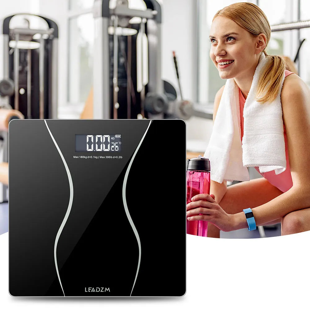 Black electronic household scale with digital display for weight measurement up to 180 kilograms