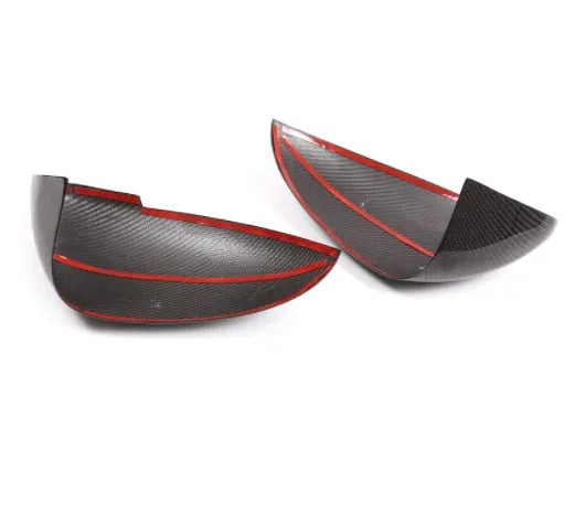Pair of black true carbon fibre rearview mirror covers for Porsche Macan on a white background.