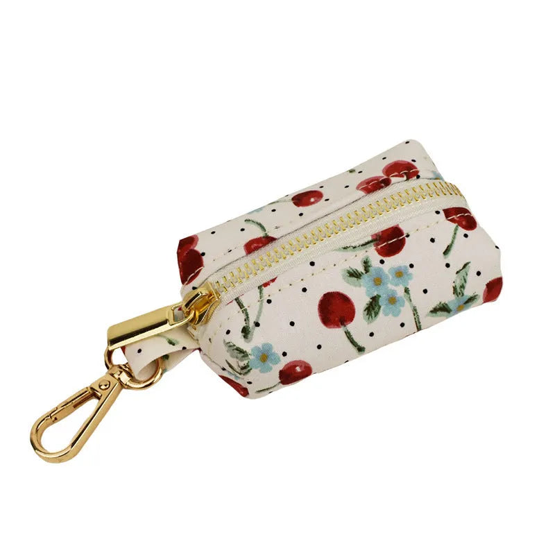 Red cherry printed dog collar set with light gold buckle and bow strap on cloth leash