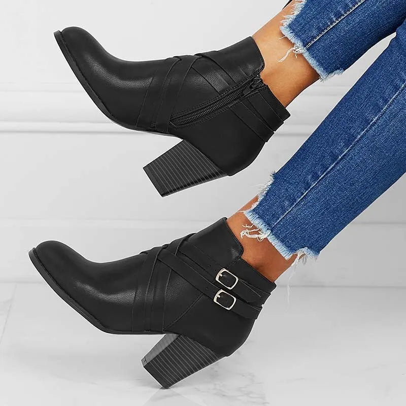 Women's grey short boot with 7cm heel, side zipper, and belt buckle detail on a rubber sole.