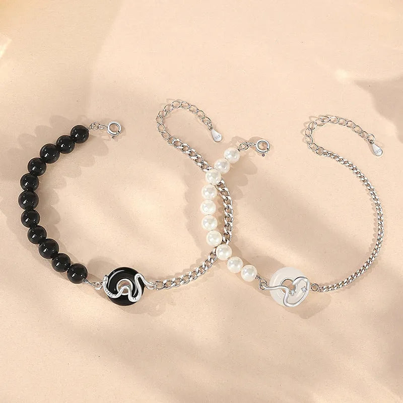 A New Chinese style 925 sterling silver couple bracelet with an obsidian pearl and snake zodiac motif on a secure buckle.