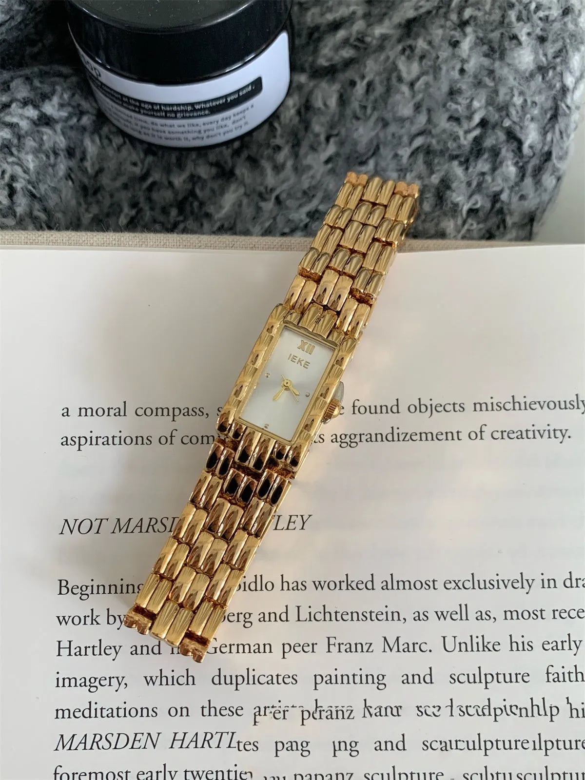 Women's stainless steel bracelet watch with 15mm dial, showing gold strap and white face option.