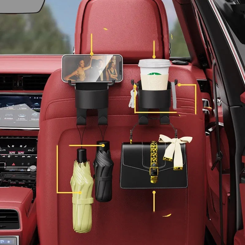 Black plastic car seat back hook organiser with cup holder mounted on vehicle headrest