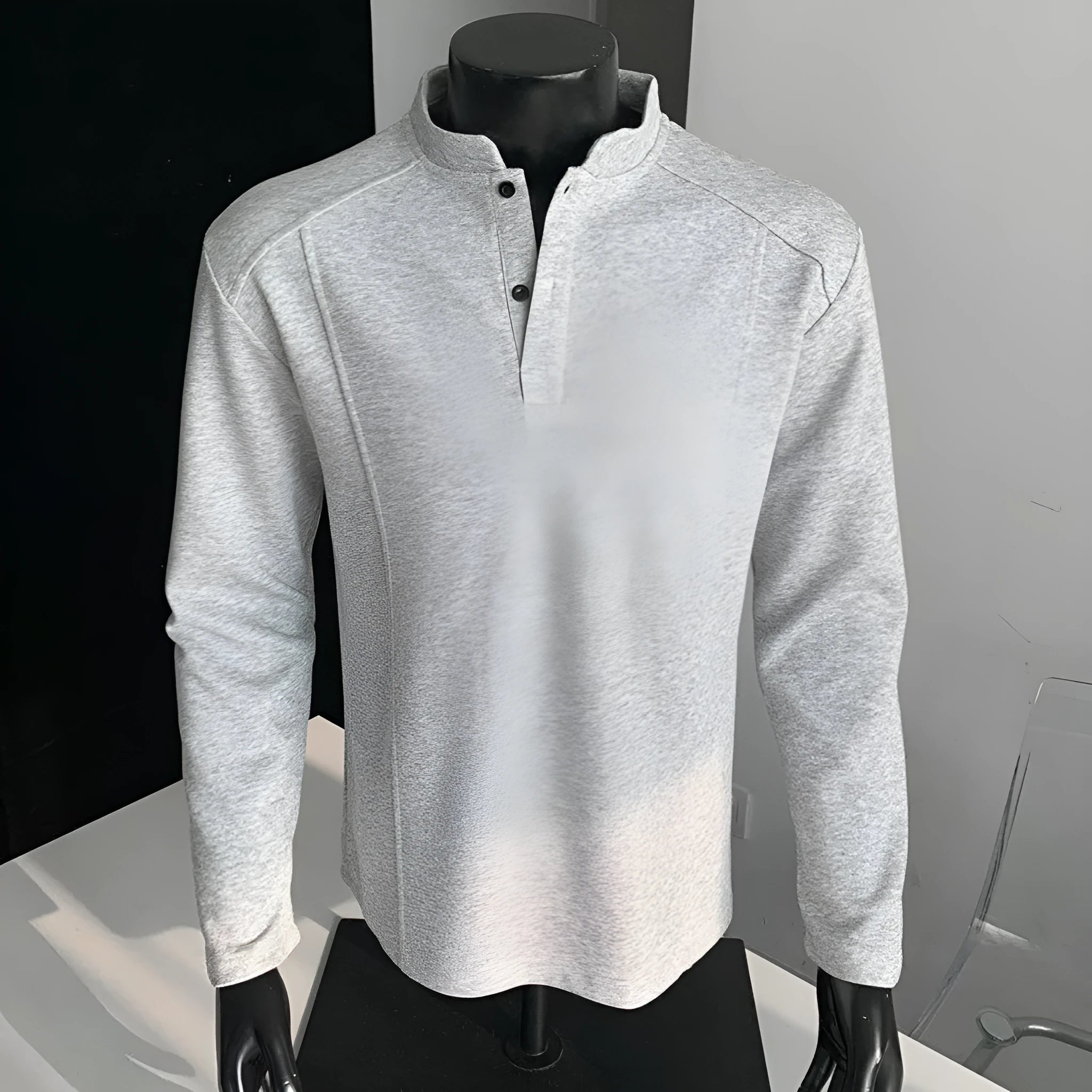 Man wearing a grey patchwork stand-up collar polo shirt with asymmetric shoulder detail