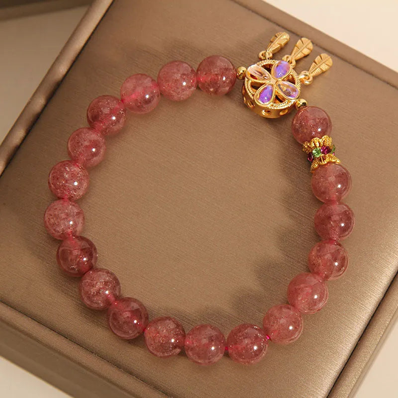 Women's strawberry quartz bracelet with four-leaf clover dream catcher pendant and silver ball charms