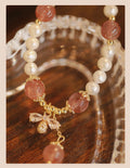 Close-up of a handmade crystal and strawberry quartz bracelet with a bow design, styled for women, INS aesthetic.