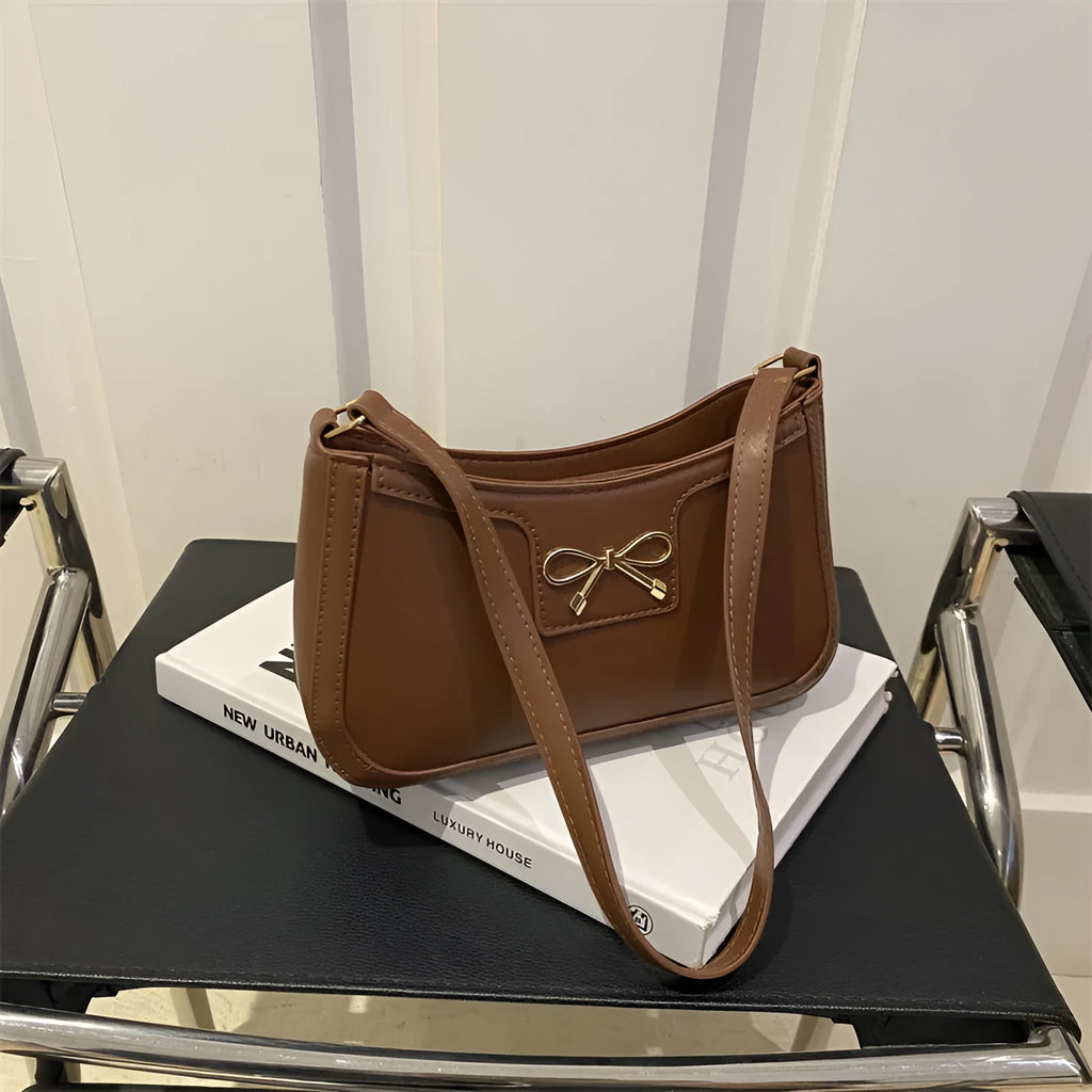 Portable PU shoulder bag in western baguette style with bow detail, 24x14x5 cm, available in multiple colours