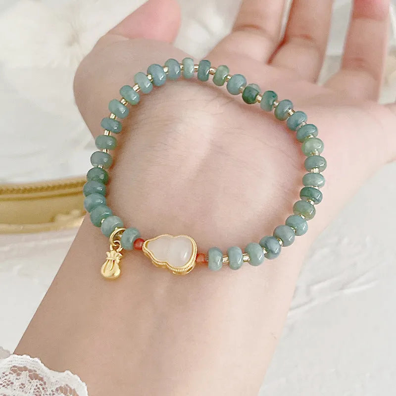Natural blue water jade bead bracelet with gourd peace buckle design on white background